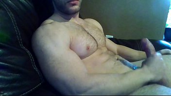 Handsome muscular man masturbates in front of the camera