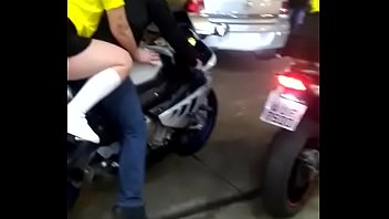 Blonde riding a motorcycle with a short skirt
