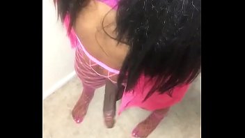 Ebony Black Tranny In Pink Swings Cock