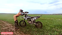 Donna nuda in sella a una Dirt Bike