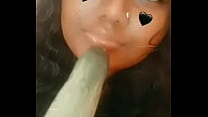some ugly indian girl sucking a cucumber