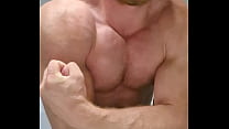 Muscular guy is doing muscle worship perfect body show