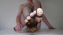 Feet in fishnet pantyhose tights